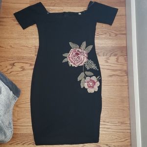 Off the shoulder black dress.